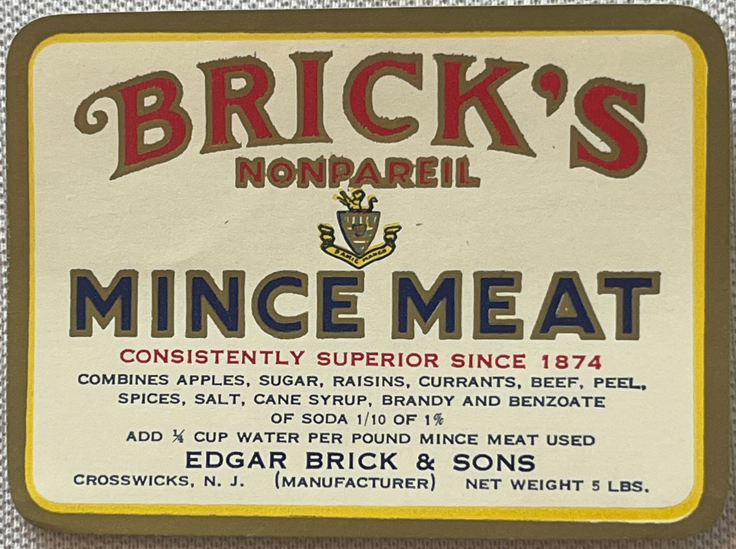 Vintage Brick's Nonpareil Mince Meat label, 5 lb size, red and blue text on cream background with yellow border