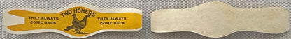 Vintage cigar band with yellow front featuring rooster and "Two Homers" text, plain back shown for comparison against texture
