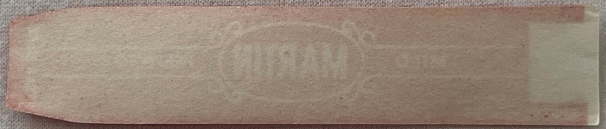 Vintage Martin Mild Perfecto cigar band label with burgundy red embossed text on tan paper, displayed flat against gray fabri