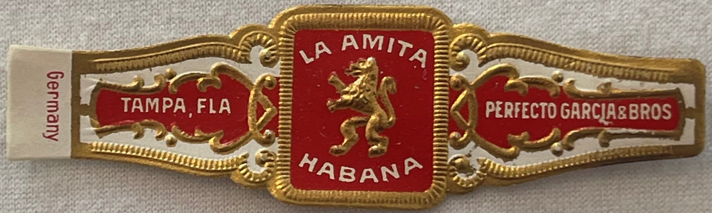 Ornate gold and red cigar band with "La Amita Habana" center emblem, "Tampa Fla" and "Perfecto Garcia & Bros" side panels, "G