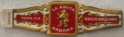 Ornate gold and red cigar band with "La Amita Habana" center emblem, "Tampa Fla" and "Perfecto Garcia & Bros" side panels, "G