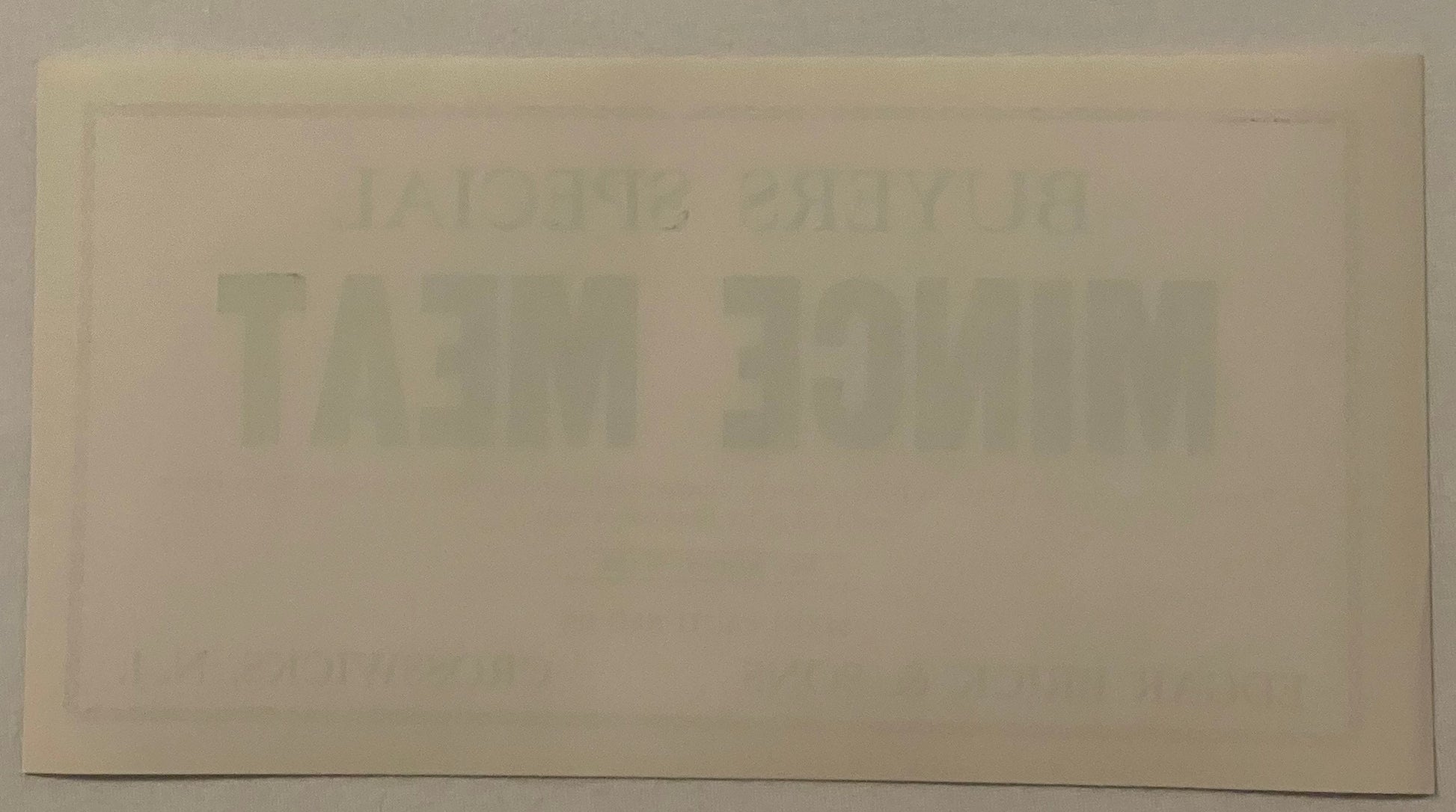Back of the Buyers Special mince meat label: blank cream paper with no printing at all, showing only the front's BUYERS SPECIAL MINCE MEAT lettering ghosting through the sheet in mirror image