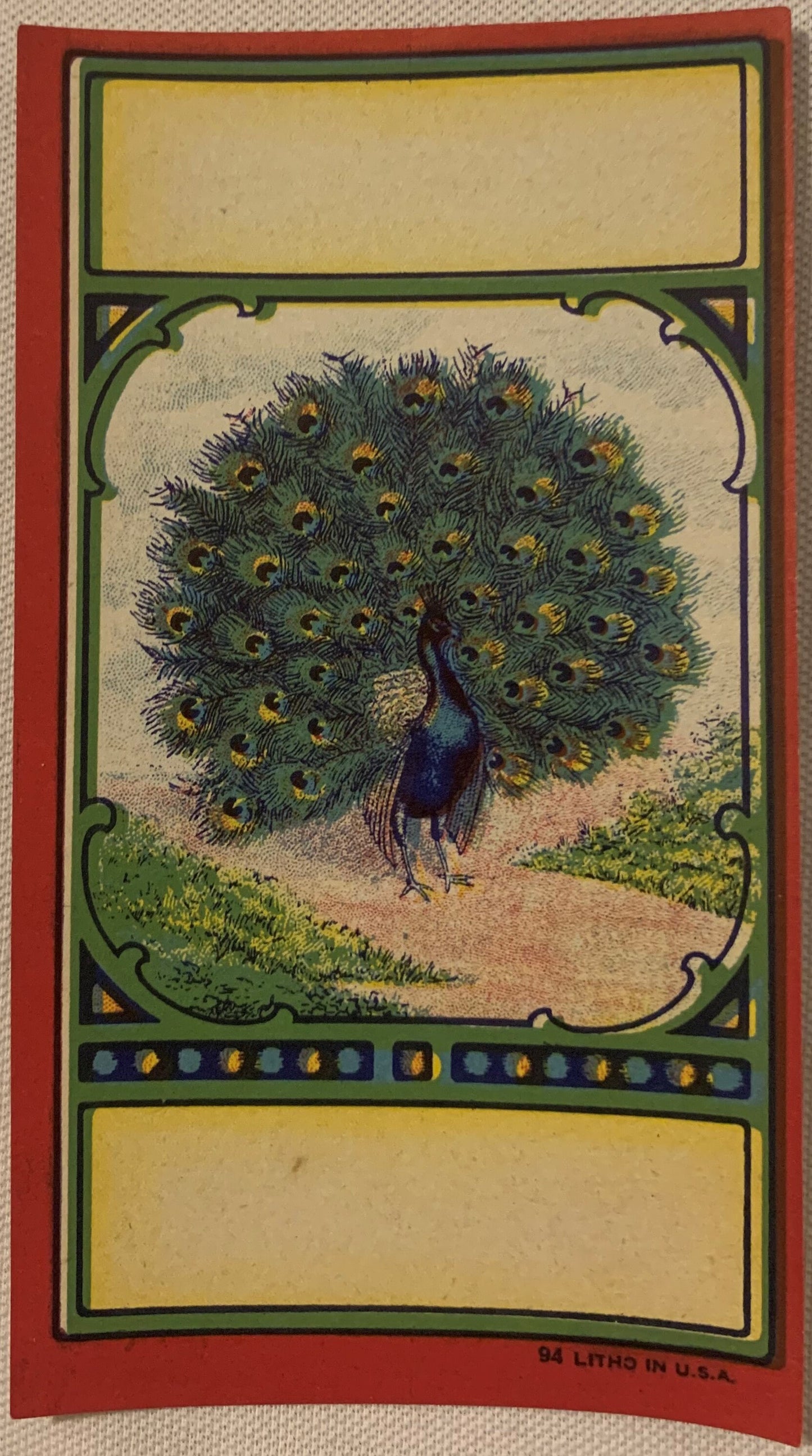 Antique chromolithograph broom label featuring a peacock with spread tail feathers in green and gold, bordered by decorative 