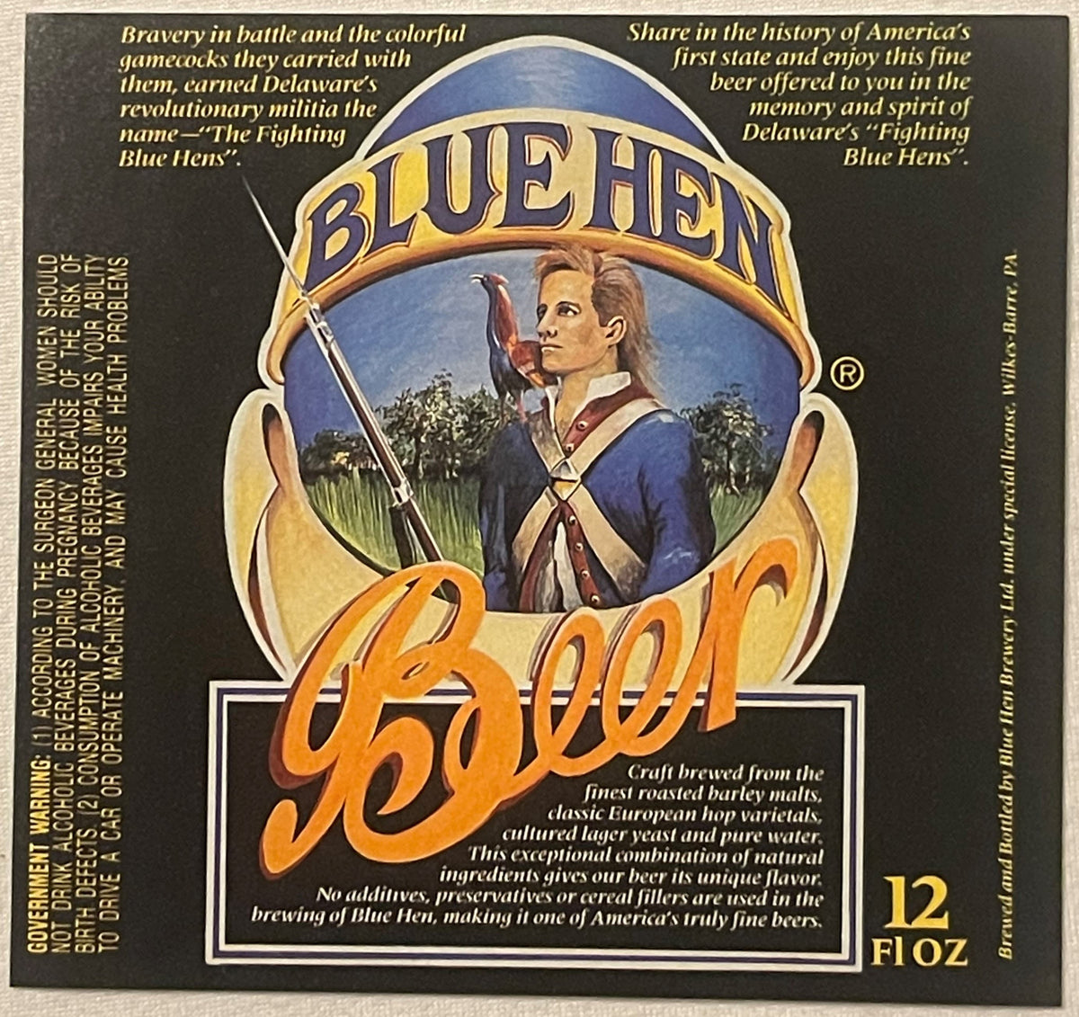 Vintage Blue Hen beer label featuring a colonial soldier with rifle against blue background, gold and orange lettering, 12 fl