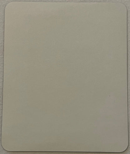 The reverse of the label: plain matte cream paper, rounded corners, no printing, no imprint and no adhesive pattern.