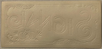 Embossed gold cigar label with "Signal" text and ornamental scrollwork borders on cream-colored paper, photographed flat.