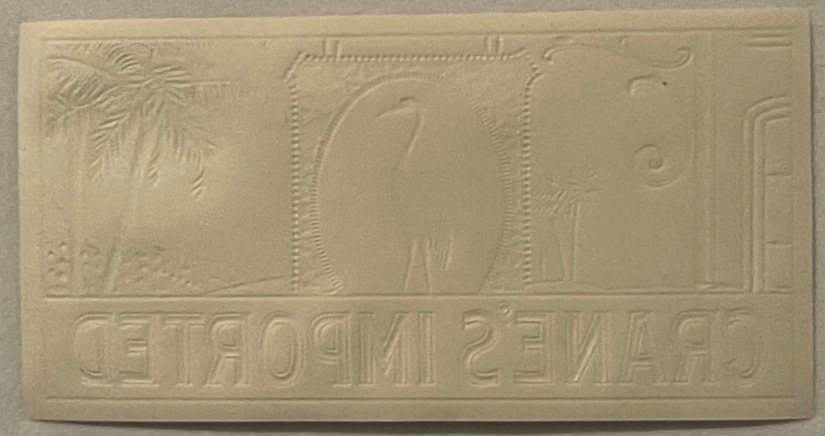 Cream-colored embossed cigar label featuring Egyptian imagery with hieroglyphics and decorative borders, photographed flat ag