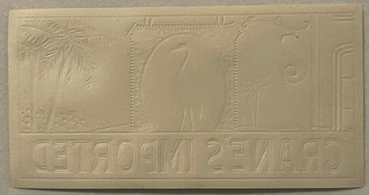 Cream-colored embossed cigar label featuring Egyptian imagery with hieroglyphics and decorative borders, photographed flat ag