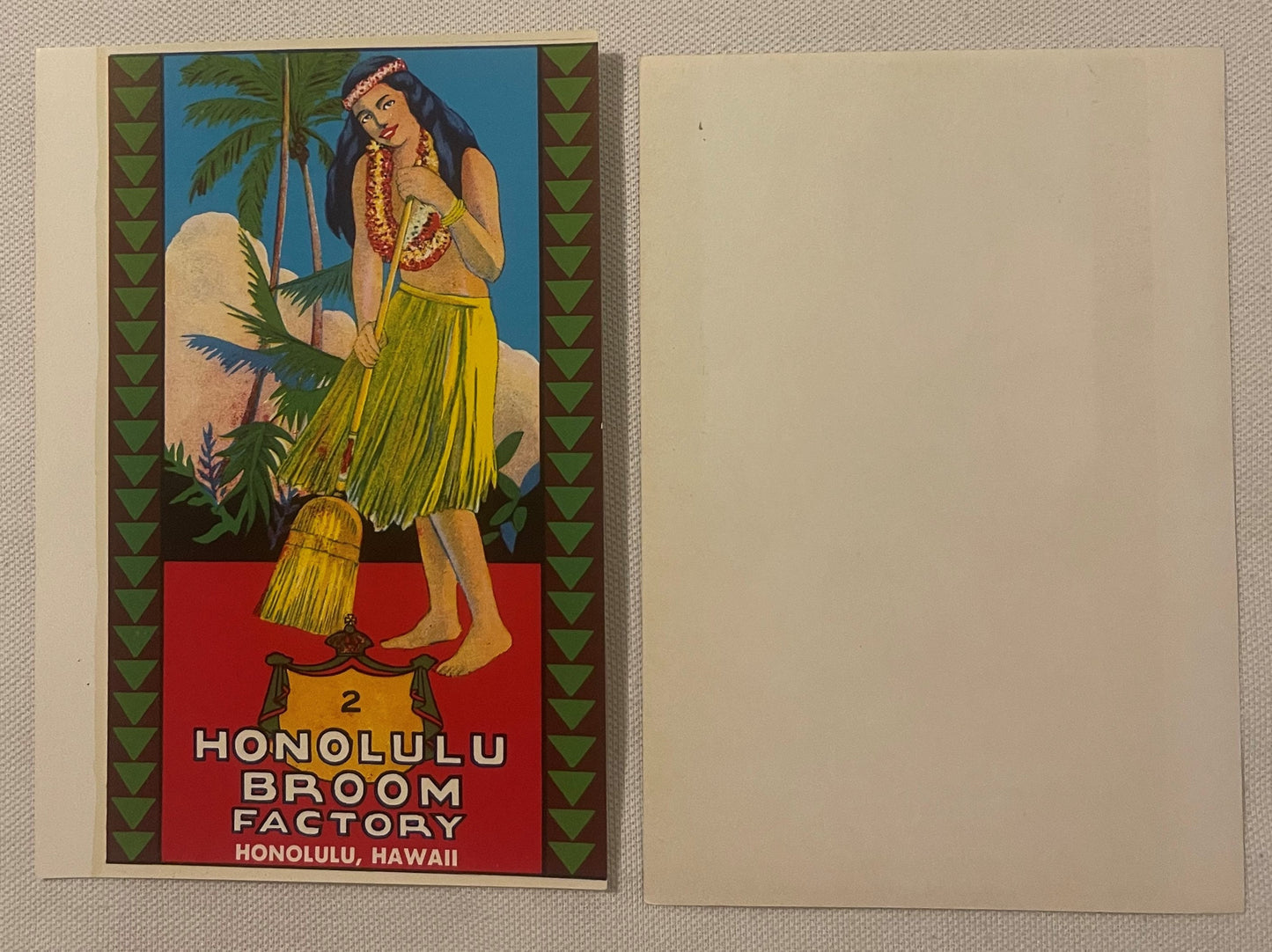 Vintage chromolithograph label for Honolulu Broom Factory showing hula girl in grass skirt with lei, palm trees, and geometri