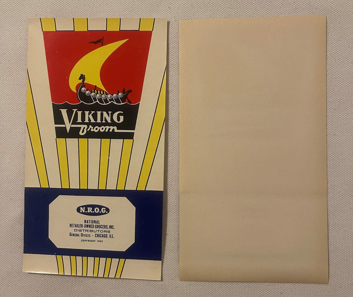 Antique 1935 Viking Broom label front beside its plain blank back, the longship and gold sail on red above yellow rays and the blue N.R.O.G. band