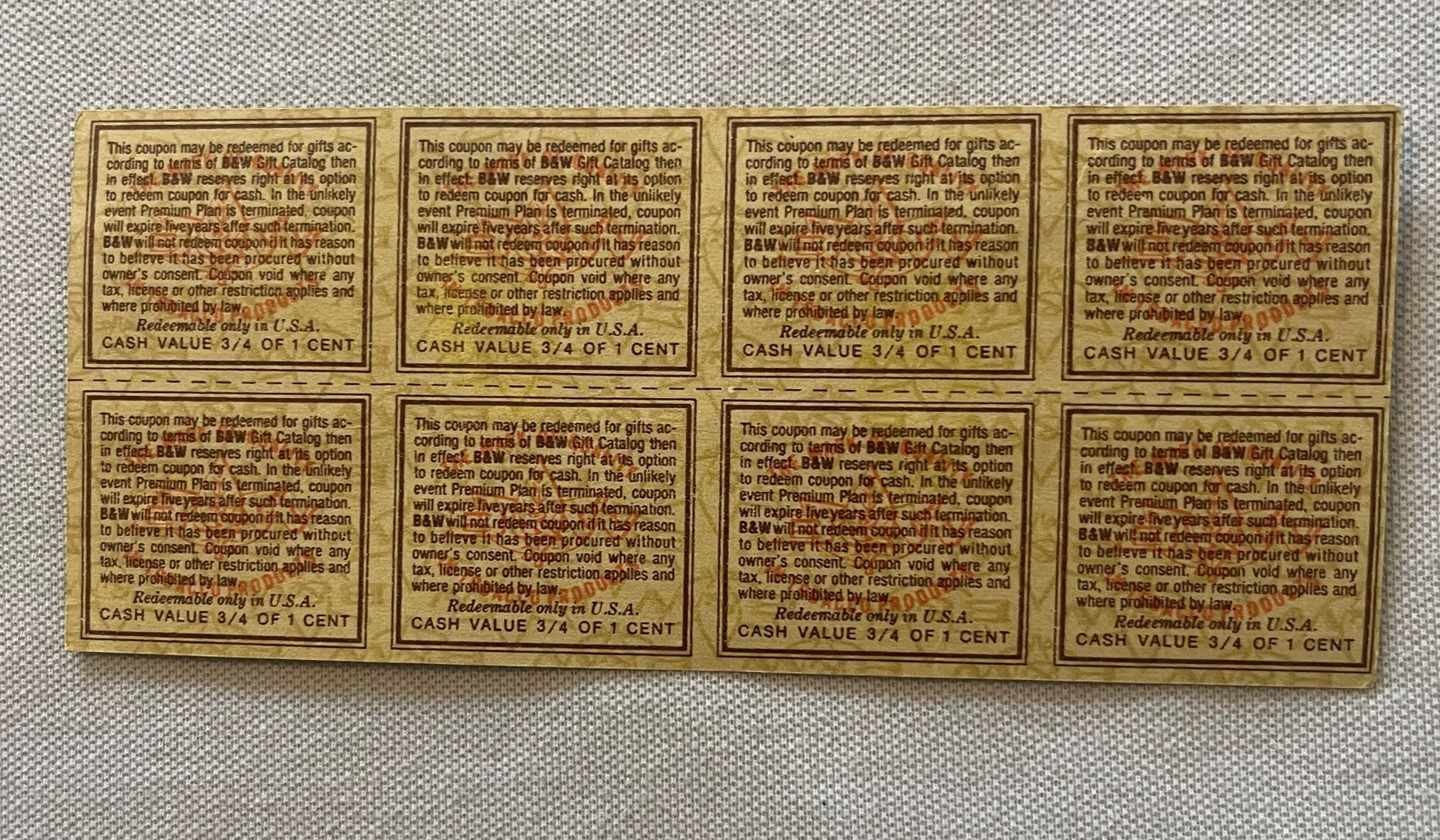 Uncut sheet of eight tan and brown vintage B&W tobacco coupons with printed text, each valued at 3/4 of one cent, arranged in