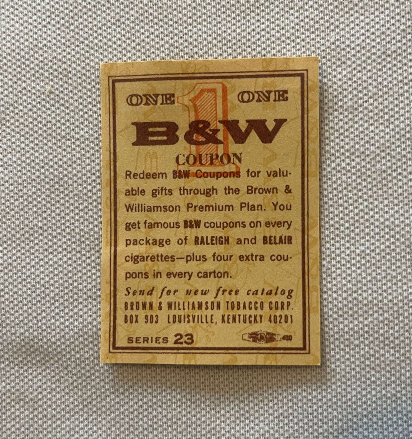 Vintage B&W tobacco coupon on tan cardboard with brown text and borders, Series 23, from Brown & Williamson Tobacco Corp Loui