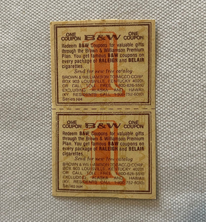 Two vintage B&W tobacco coupons from Brown & Williamson stacked vertically on beige fabric, printed text and orange logo visi