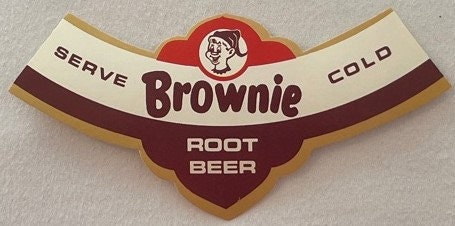 Vintage Brownie Root Beer neck label with red and brown design, white and tan panels reading "SERVE COLD ROOT BEER," featurin