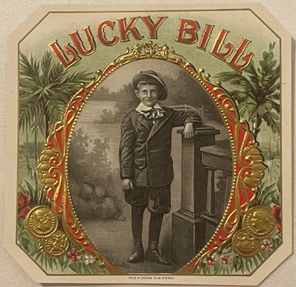 Gold-embossed "Lucky Bill" cigar label featuring young boy in hat and suit leaning against pedestal, ornate red and gold fram