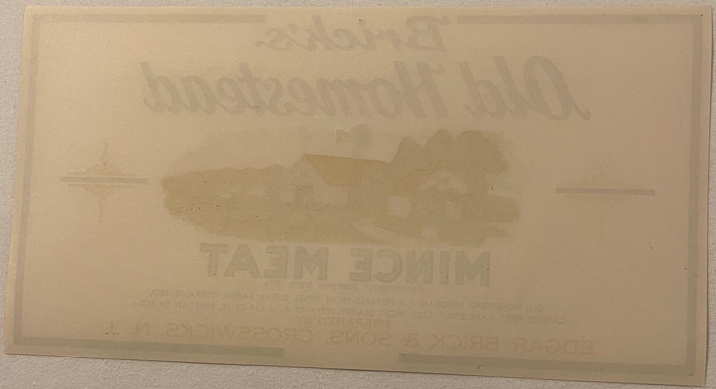 Cream-colored antique label with embossed text and central image, legible text includes "BRICK'S OLD HOMESTEAD"