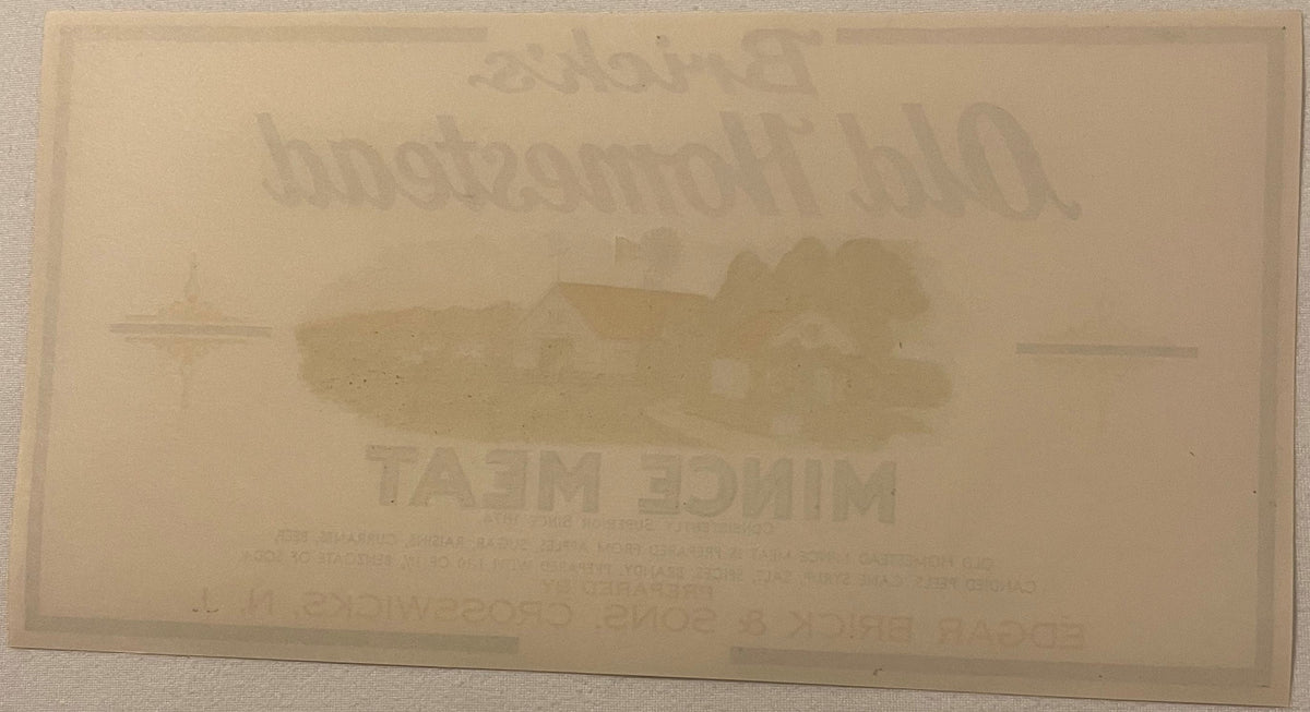 Cream-colored antique label with embossed text and central image, legible text includes "BRICK'S OLD HOMESTEAD"