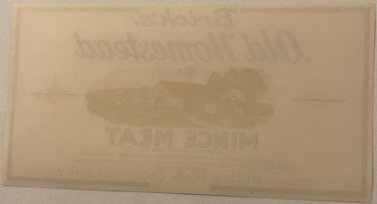 Cream-colored antique label with embossed text and central image, legible text includes "BRICK'S OLD HOMESTEAD"