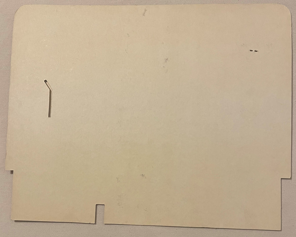Cream-colored cardboard die-cut display sign with rectangular cutouts and a bent metal tab, shown flat against textured