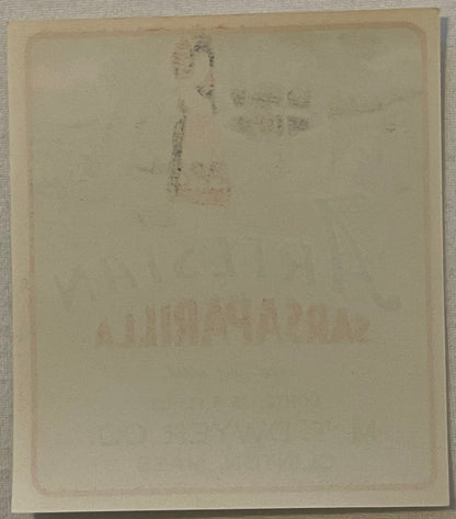 Reverse of the Artesian Sarsaparilla label, close up: plain paper with the front artwork and lettering showing faintly through from the other side.