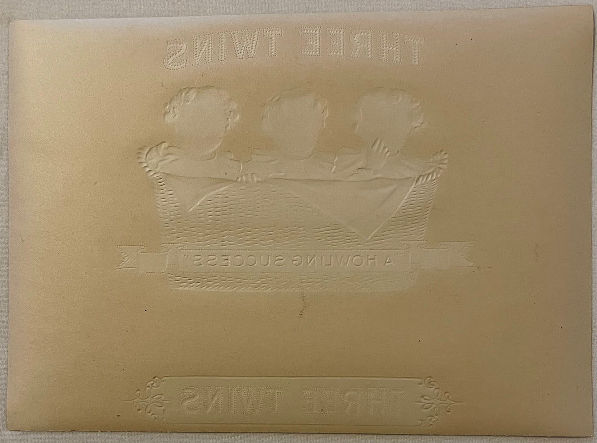 Embossed cream-colored cigar box label featuring three baby heads above a decorative banner with "Howling Success" text, show