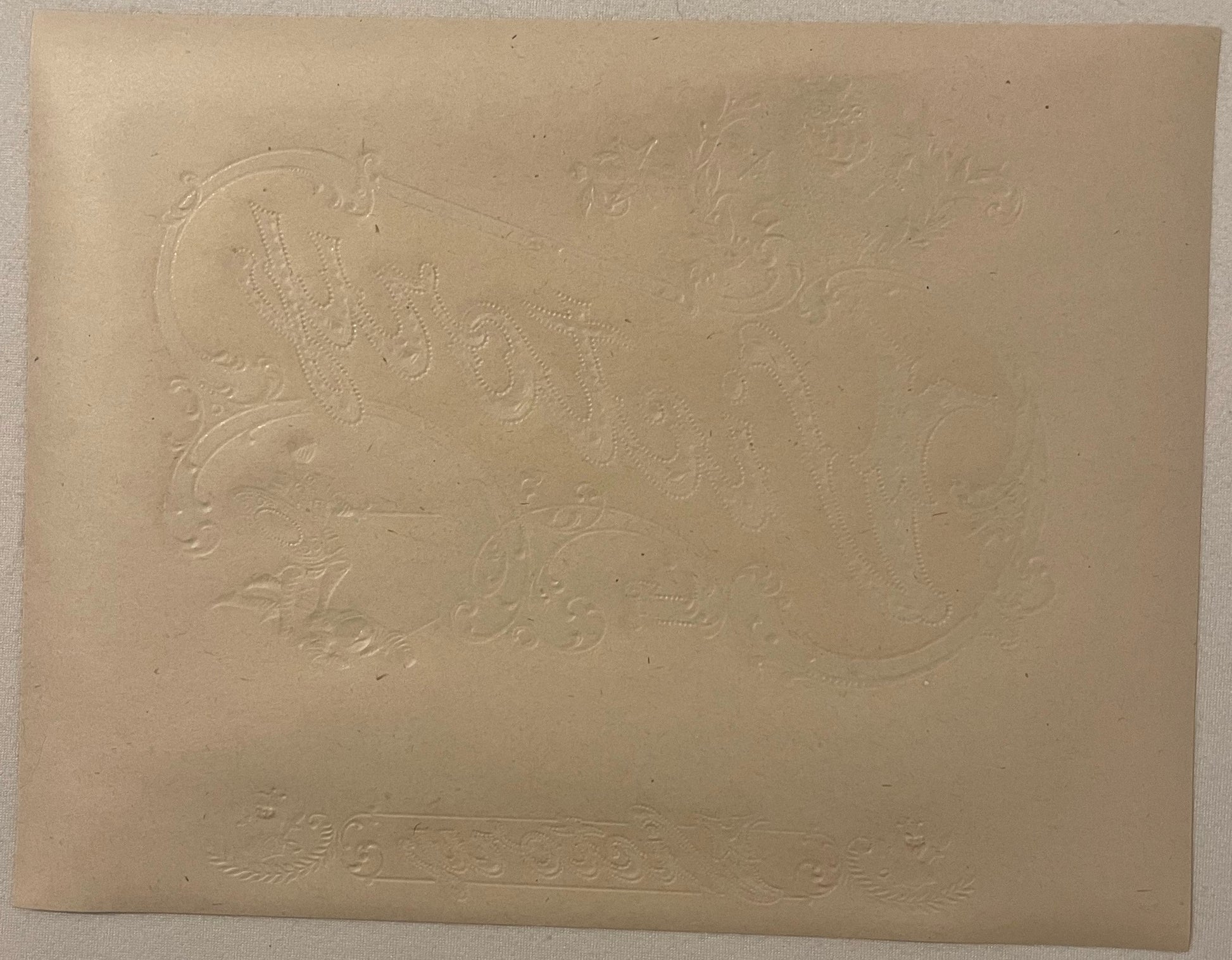 Embossed cream-colored cigar label with Roman gladiator design and decorative scrollwork borders, shown flat against neutral 