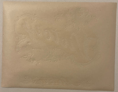 Embossed cream-colored cigar label with Roman gladiator design and decorative scrollwork borders, shown flat against neutral 