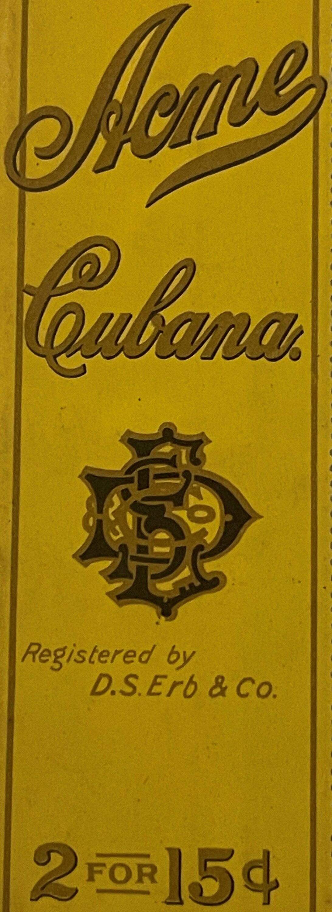 Yellow embossed cigar bag label reading "Acme Cubana" with ornate monogram, registered by D.S. Erb & Co, priced 2 for 15¢