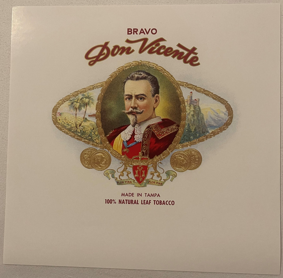 Vintage cigar box label featuring a bearded man in red royal attire within ornate gold frame, with "BRAVO Don Vicente" text a