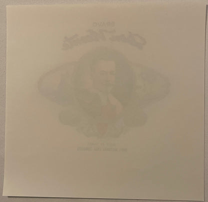 Faded embossed cigar box label showing a man's portrait, tan paper background, barely legible text at top and bottom