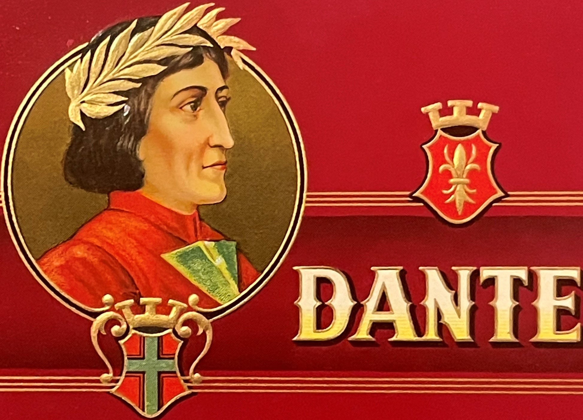 Antique cigar box label featuring a profile portrait of Dante Alighieri wearing a laurel wreath and red robe, with gold embos