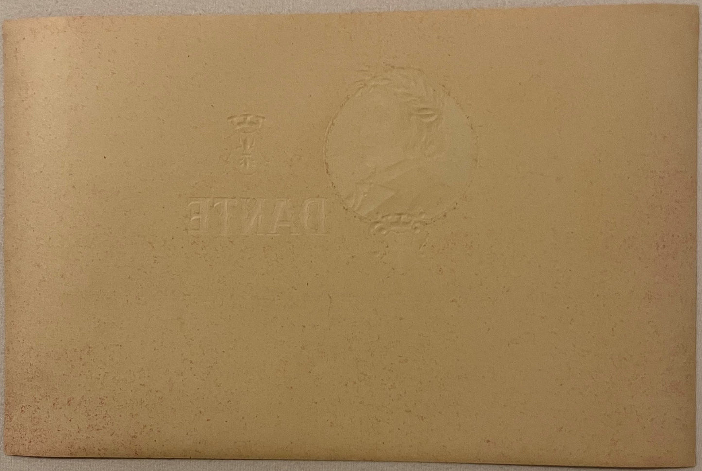 Tan cardstock with embossed portrait in oval frame and text reading "DANTE" and "SULZBERGER-OPPENHEI", photographed flat on t