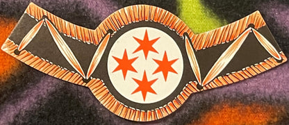 Antique wine neck label with orange wings flanking a cream circle containing four red stars, on dark textured background