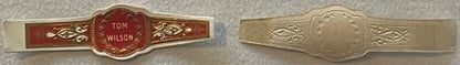 Front and back of vintage Tom Wilson cigar band showing ornate red and gold design with embossed cream-colored reverse side.