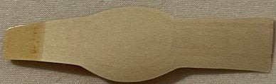Tan cardboard cigar band with curved waist cutout, displayed flat on textured fabric background