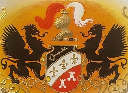 Gold embossed cigar label featuring two black dragons flanking a heraldic shield with fleur-de-lis and castle designs on oran
