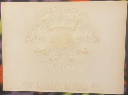 Embossed cream-colored cigar box label with raised text reading Garcia Y Garcia and Tampa Factory, shown flat against multico