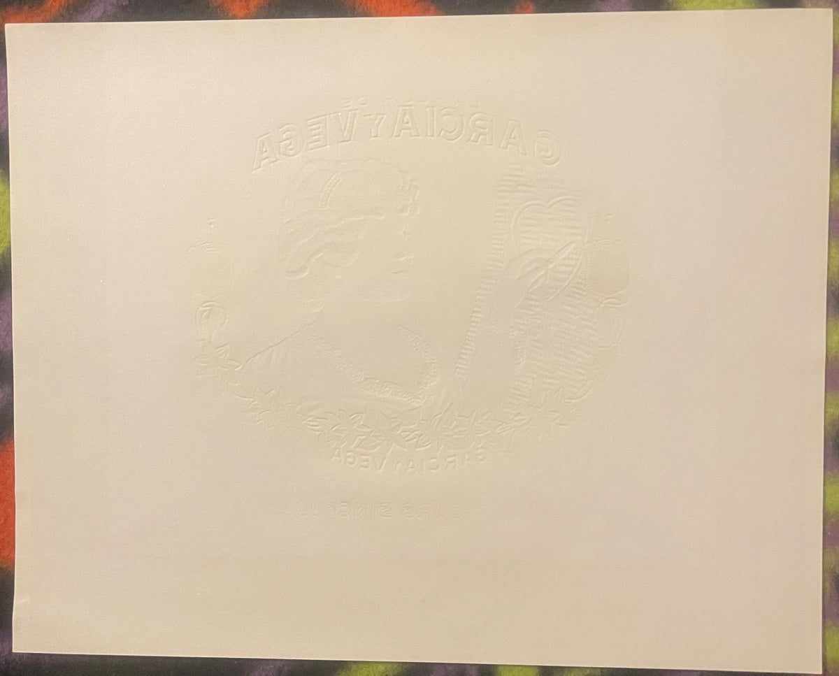 Cream-colored embossed cigar box label with "Garcia y Vega" text and decorative leaf design in raised gold foil detail