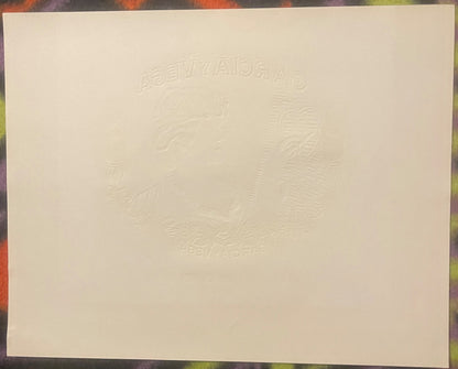 Cream-colored embossed cigar box label with "Garcia y Vega" text and decorative leaf design in raised gold foil detail