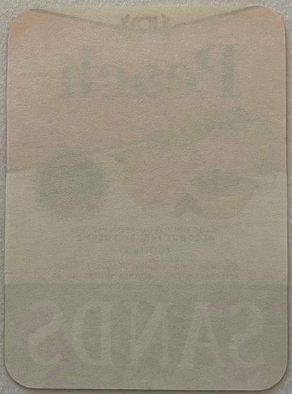 The reverse of the label: plain unprinted paper, rounded corners. What shows through faintly is the front's own ink coming through the sheet, not printing on the back.