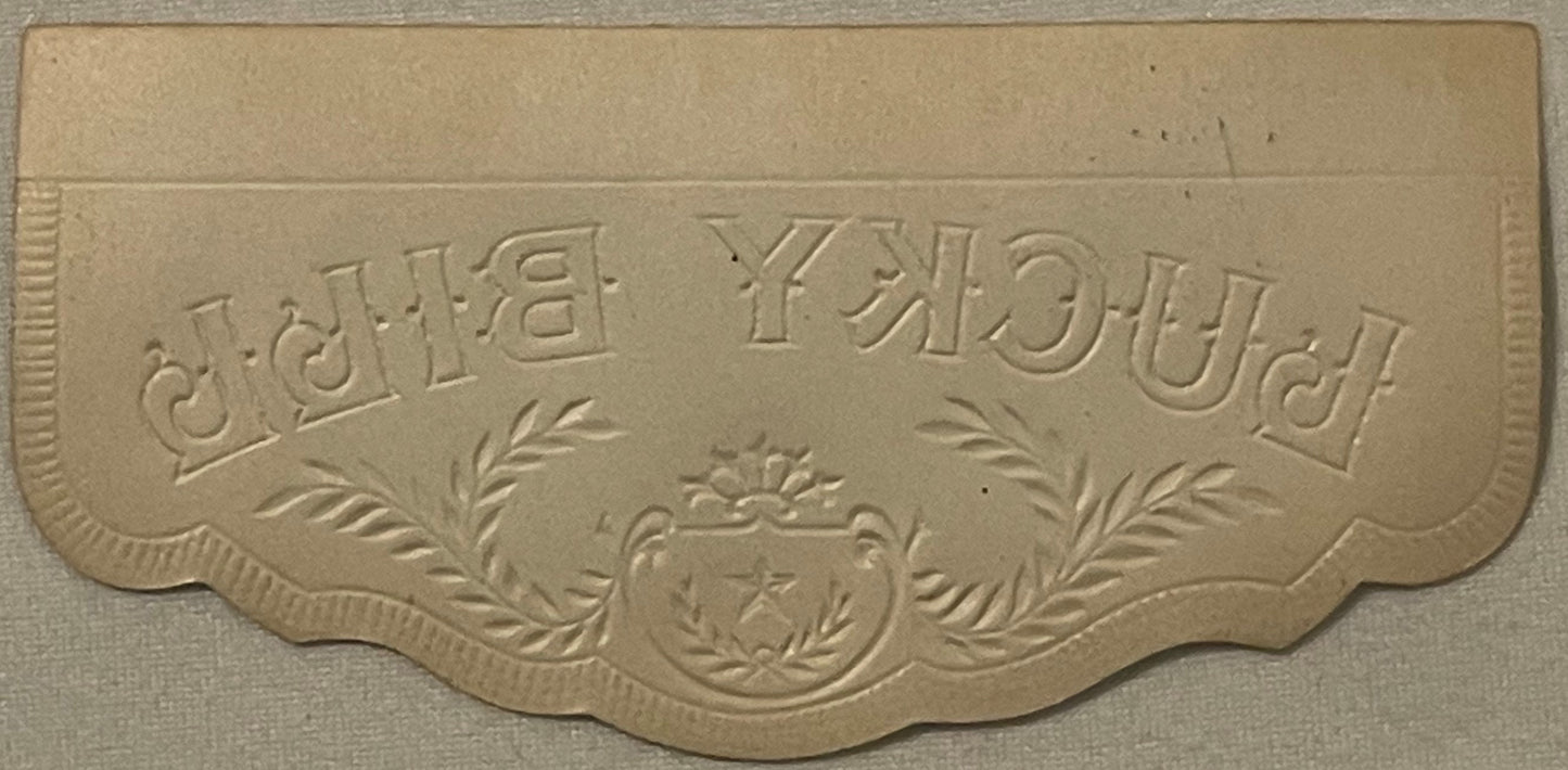 Cream-colored embossed cigar box label with ornate border and central crest, text reading "Lucky" and "Bill" in decorative le