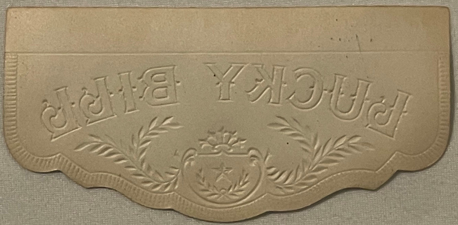 Cream-colored embossed cigar box label with ornate border and central crest, text reading "Lucky" and "Bill" in decorative le