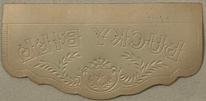 Cream-colored embossed cigar box label with ornate border and central crest, text reading "Lucky" and "Bill" in decorative le