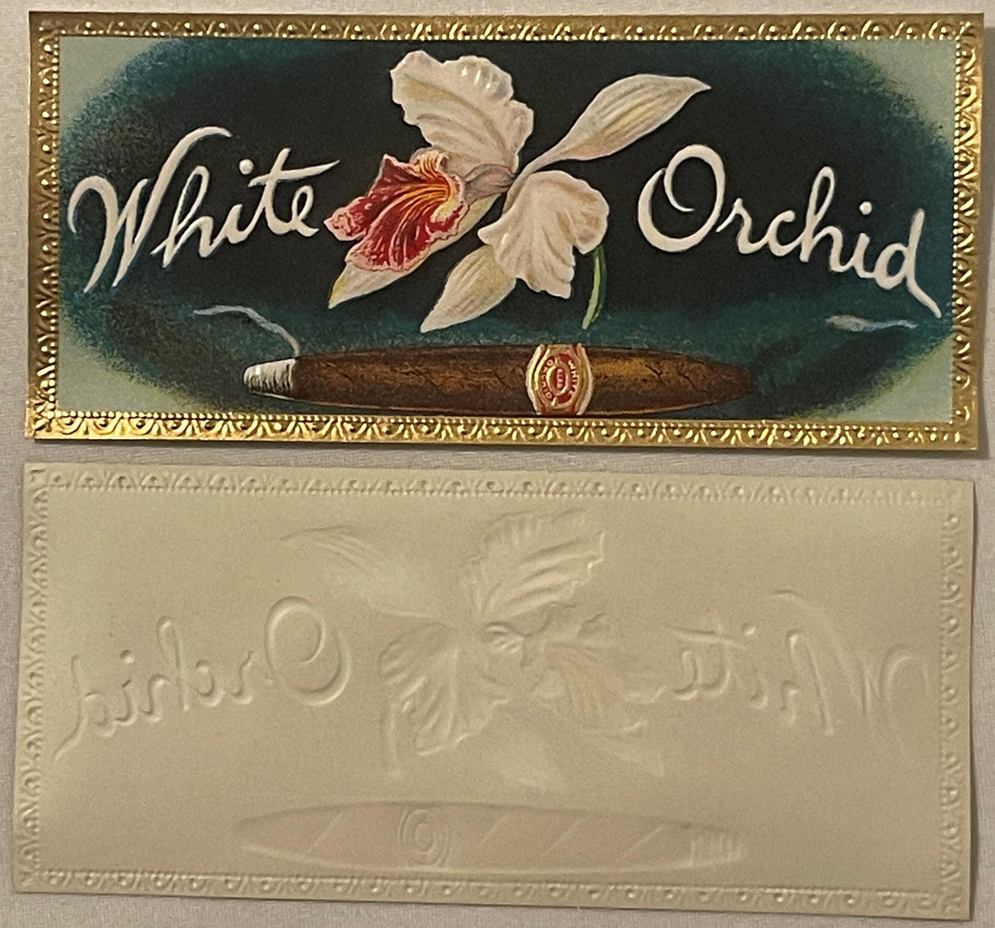 Antique cigar box label with white orchid flower and cigar illustration, embossed gold border, cream and dark green backgroun