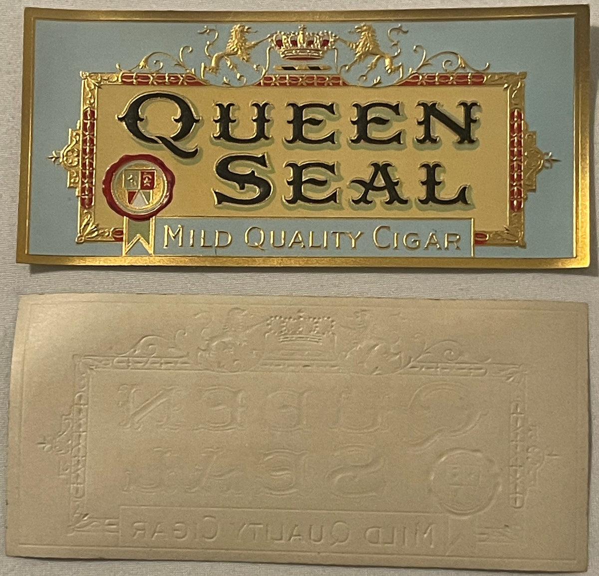 Gold embossed cigar box label for "Queen Seal" mild quality cigar, shown front and back, featuring ornate crown and heraldic 