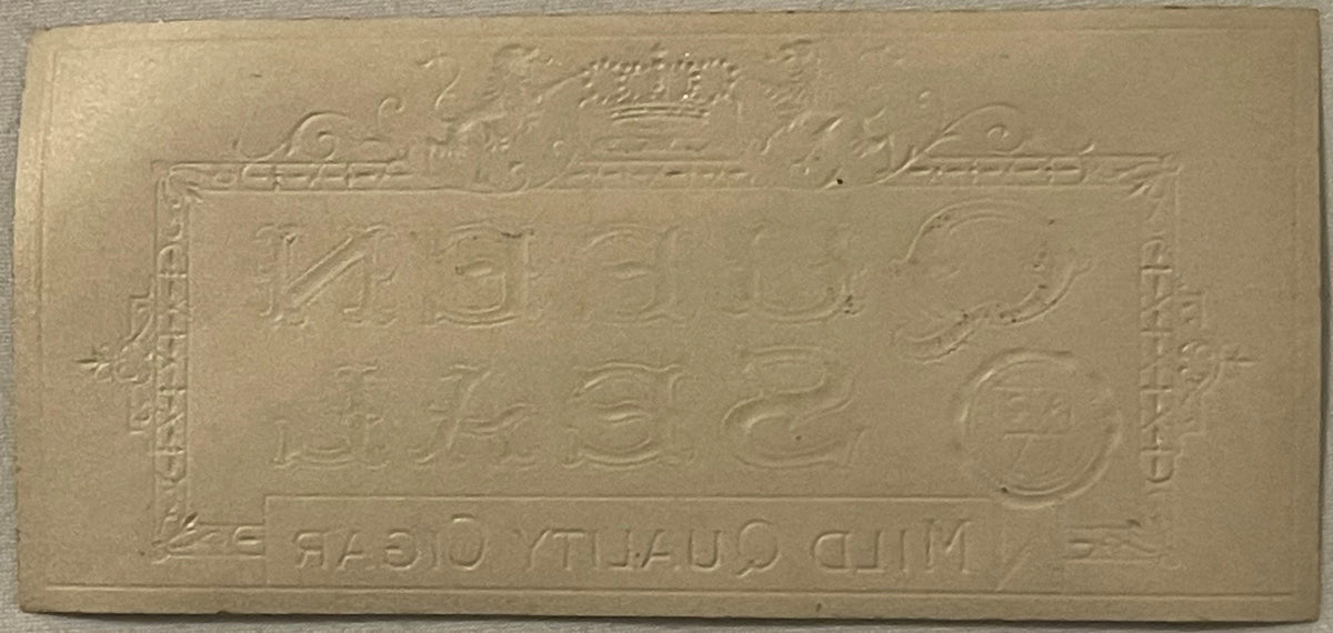Cream-colored embossed cigar box label with gold crown at top and ornamental borders, featuring numbers and reversed text at 