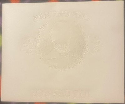 Embossed cream-colored cigar box inner label featuring a wreathed portrait, with text reading "Joe Cannon" and other partiall