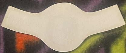 Blank cream-colored curved wine bottle neck label against colorful textured background with orange and green tones