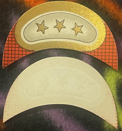 Two cream and gold embossed wine bottle labels with three-star and crescent moon designs, displayed stacked on a dark pattern