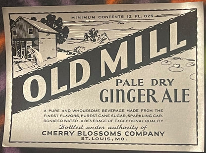 Vintage ginger ale label featuring "Old Mill" text, rural farm scene, and "Cherry Blossoms Company St. Louis MO" printed in b